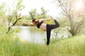 Pregnant beautiful woman yoga outdoors on the grass in sunny summer day Royalty Free Stock Photo