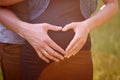 Pregnant Belly with fingers Heart symbol Royalty Free Stock Photo