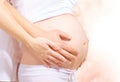 Pregnant belly with hands of mother and father Royalty Free Stock Photo