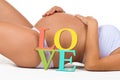 Pregnant belly with a sign Love. Concept of pregnancy and love pregnant woman to child