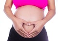 Pregnant Belly of woman with fingers Heart shape on white background Royalty Free Stock Photo