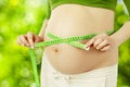 Pregnant belly, woman measure stomach. Prenatal health care