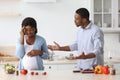 Pregnant black woman fighting with her husband while cooking together