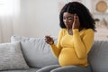 Pregnant black woman having headache, measuring temperature Royalty Free Stock Photo