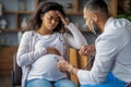 Pregnant black woman suffering from migraine, visiting doctor Royalty Free Stock Photo