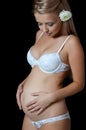 The pregnant blonde woman On a black Royalty Free Stock Photo