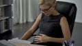 Pregnant business woman hardly breathing in office, preterm birth, health care