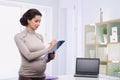 Pregnant business woman in the office Royalty Free Stock Photo