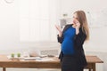 Pregnant business woman talking on phone at office Royalty Free Stock Photo