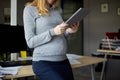 Pregnant businesswoman with tablet pc at office