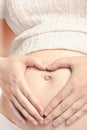 Pregnant caucasian mother with hands on belly Royalty Free Stock Photo