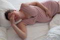 Pregnant caucasian woman lying on bedbeing tired Royalty Free Stock Photo