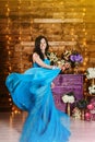 Pregnant cheerful beautiful woman stands wrapped in silk fabric and laughs Royalty Free Stock Photo