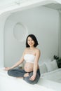 Pregnant Chinese Asian female sitting cross legged in living room Royalty Free Stock Photo