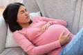 Pregnant Chinese Lady Suffering From Pain Touching Belly At Home Royalty Free Stock Photo