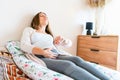 Pregnant contractions time. Pregnancy woman watching clock, holding baby belly. Childbirth time, contractions pain Royalty Free Stock Photo