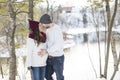 Pregnant couple have fun in winter nature Royalty Free Stock Photo