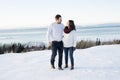 Pregnant couple have fun in winter nature Royalty Free Stock Photo