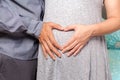 Pregnant couple with heart hands Royalty Free Stock Photo