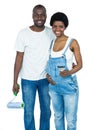 Pregnant couple holding a paint roller Royalty Free Stock Photo
