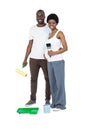 Pregnant couple holding roller paint and paint brush Royalty Free Stock Photo