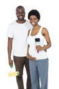Pregnant couple holding roller paint and paint brush Royalty Free Stock Photo