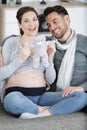 Pregnant couple holding soft teddy bear Royalty Free Stock Photo