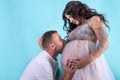 Pregnant couple. Man kissing his beautiful wife in belly. Waiting for a baby Royalty Free Stock Photo