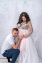 Pregnant couple. Man kissing his beautiful wife in belly. Waiting for a baby Royalty Free Stock Photo