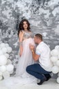 Pregnant couple. Man kissing his beautiful wife in belly. Waiting for a baby Royalty Free Stock Photo