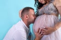 Pregnant couple. Man kissing his beautiful wife in belly. Waiting for a baby Royalty Free Stock Photo