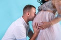 Pregnant couple. Man kissing his beautiful wife in belly. Waiting for a baby Royalty Free Stock Photo