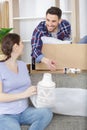 pregnant couple unpacking possessions in their new family home