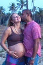 Pregnant couple walking on the beach