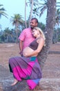 Pregnant couple walking on the beach