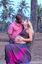 Pregnant couple walking on the beach Royalty Free Stock Photo