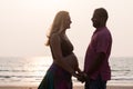 Pregnant couple walking on the beach