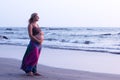 Pregnant couple walking on the beach