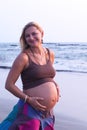 Pregnant couple walking on the beach