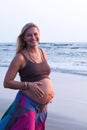 Pregnant couple walking on the beach