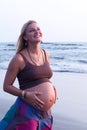 Pregnant couple walking on the beach