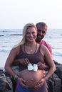 Pregnant couple walking on the beach