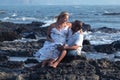 Pregnant couple walking on the beach