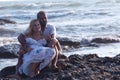 Pregnant couple walking on the beach