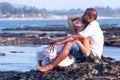 Pregnant couple walking on the beach