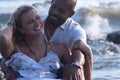 Pregnant couple walking on the beach