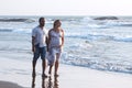 Pregnant couple walking on the beach Royalty Free Stock Photo