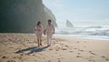 Pregnant couple walking beach summer holiday. Loving happy spouses awaiting baby Royalty Free Stock Photo