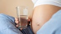 Pregnant drinking water. Young pregnancy mother drink water. Pregnant lady waiting of baby. Glass of water. Concept Royalty Free Stock Photo