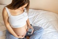 Pregnant drinking water. Young pregnancy mother drink water. Pregnant lady waiting of baby. Glass of water. Concept Royalty Free Stock Photo